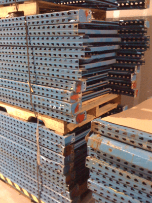 Stack of pallet rack frames with rust and dents
